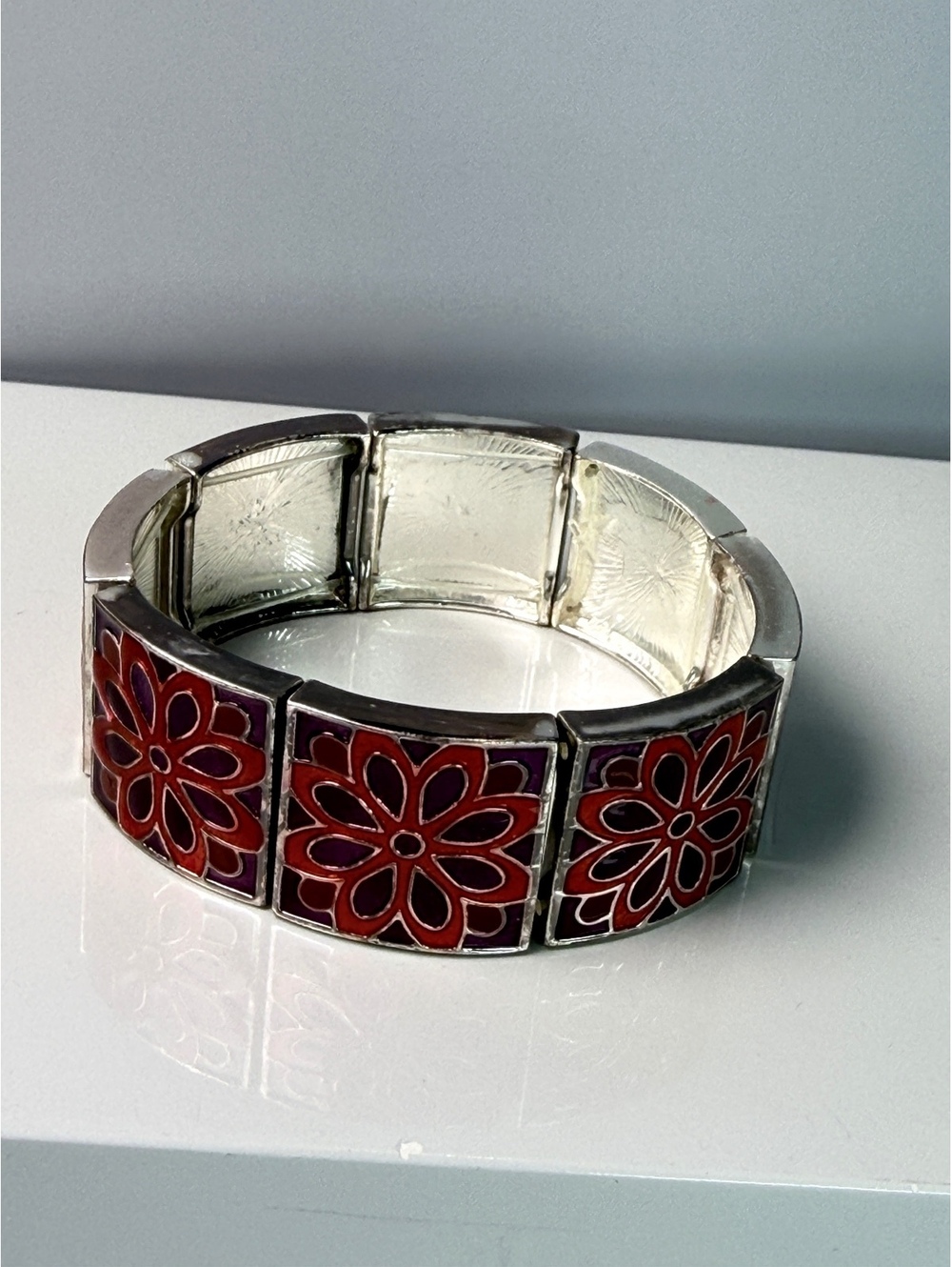 Red enamel floral panel stretch bracelet on silver tone hardware